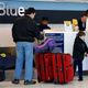 Passengers check in at the Jet Blue terminal at JFK Airport in New York City on Feb. 19, 2007. PrimeFlight Inc. subcontracts ground and terminal service employees to Jet Blue and other major airlines. (Rick Maiman/AP Images)
